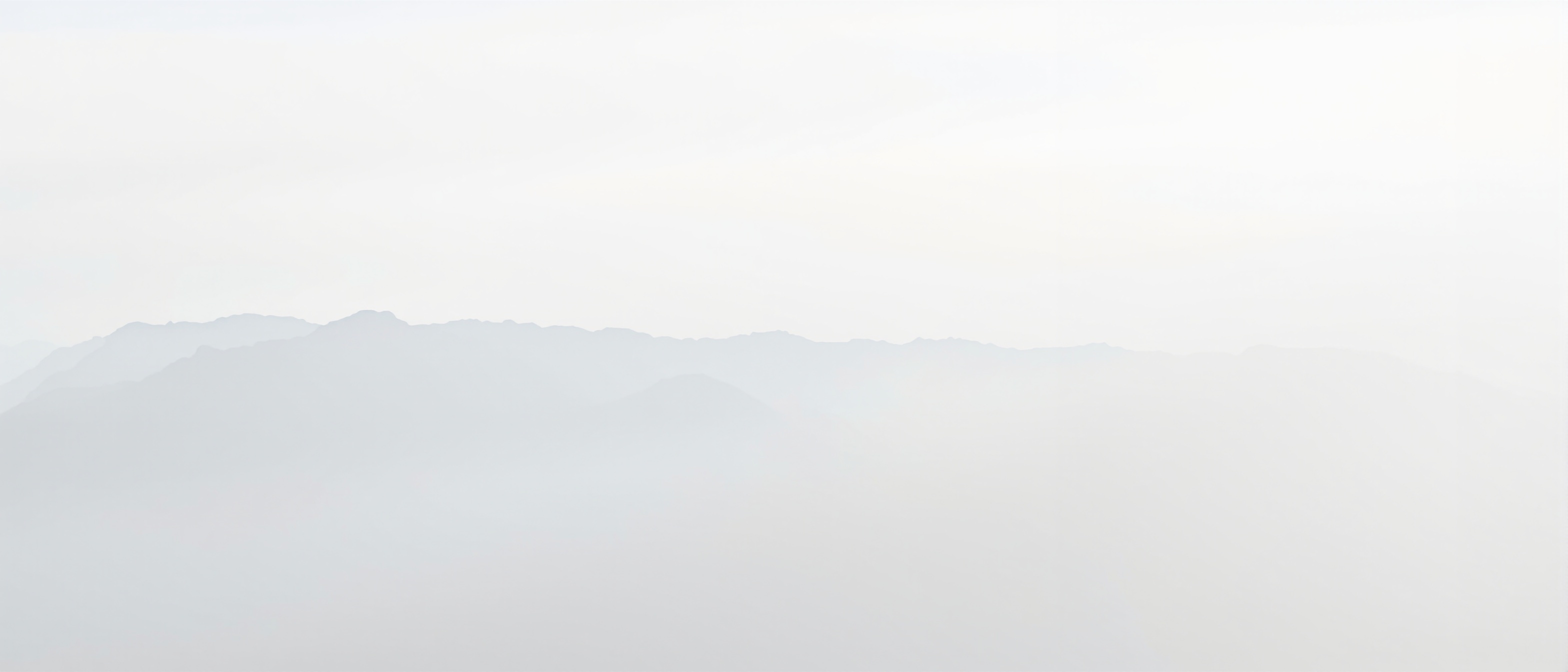 A thin veil of mist over the range at first light.